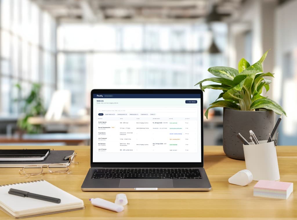 The Radly practitioner portal on a laptop: a referral list showing booking progress for each patient